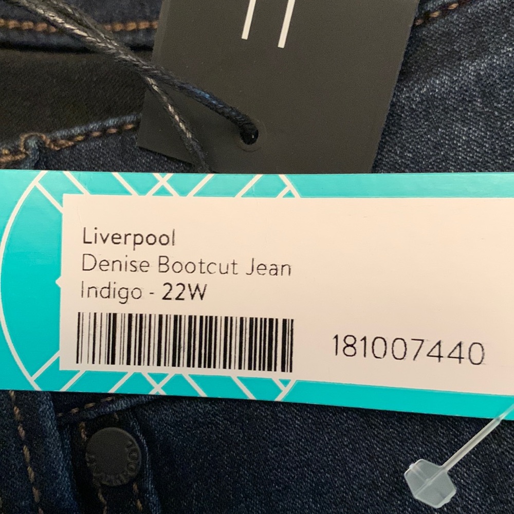 Never worn, tags on, dark blue jeans